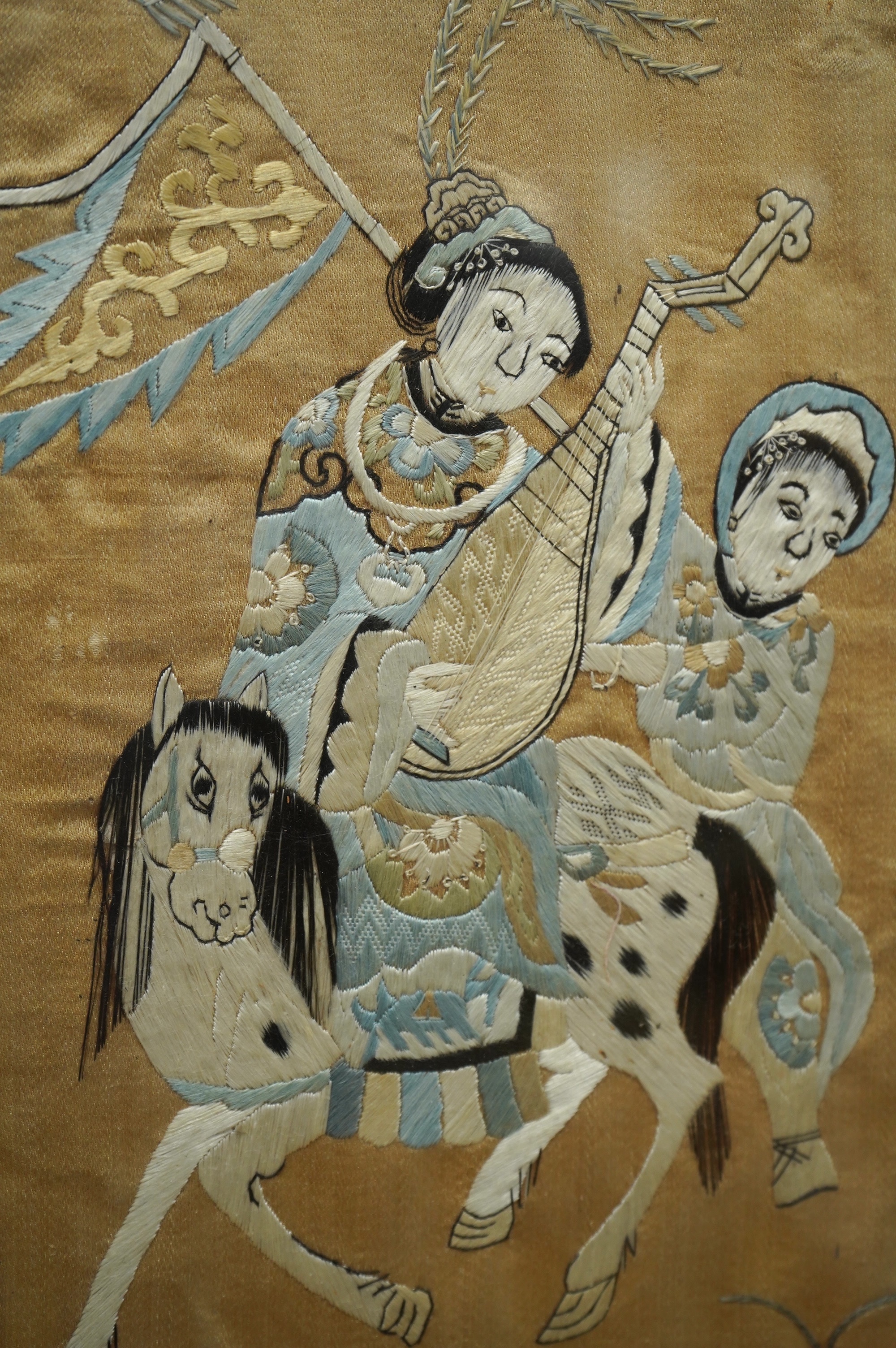 Two 19th century Chinese silk embroideries, one of a Chinese a musician on horseback and a boy behind carrying a banner, the other a Chinese knot floral embroidery of vases of flowers with brocade border, both embroideri